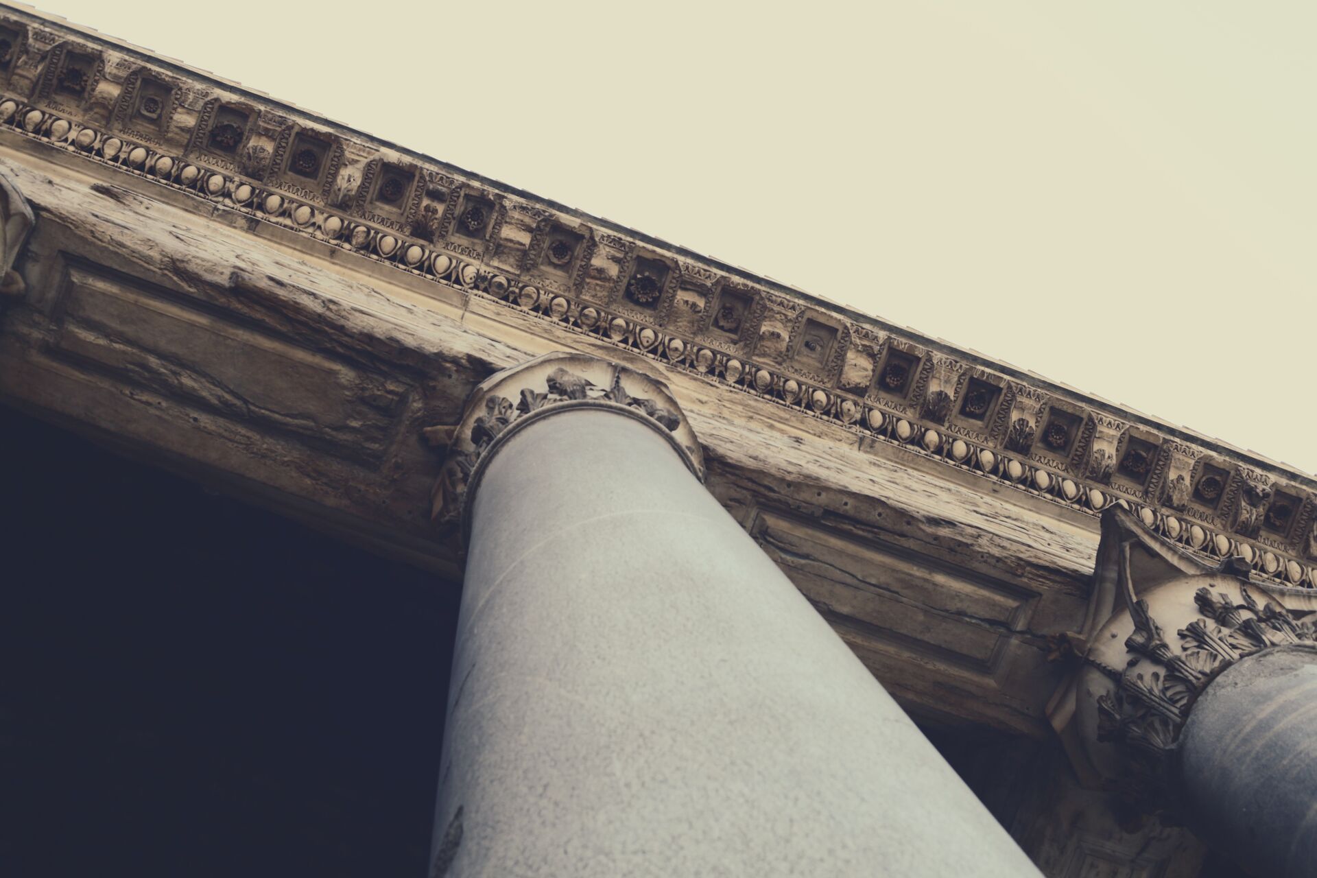 Classical stone column and carved cornice
