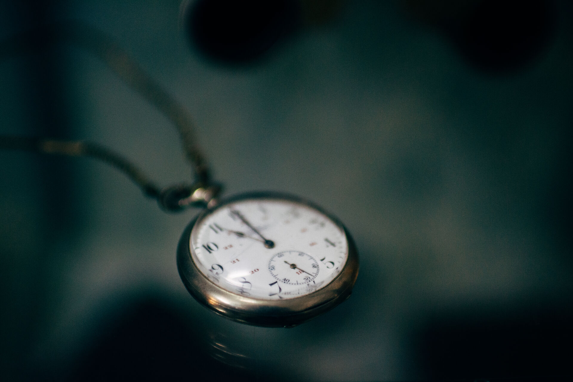 Old pocket watch on a dark table