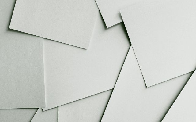 Sheets of plain paper scattered across a table
